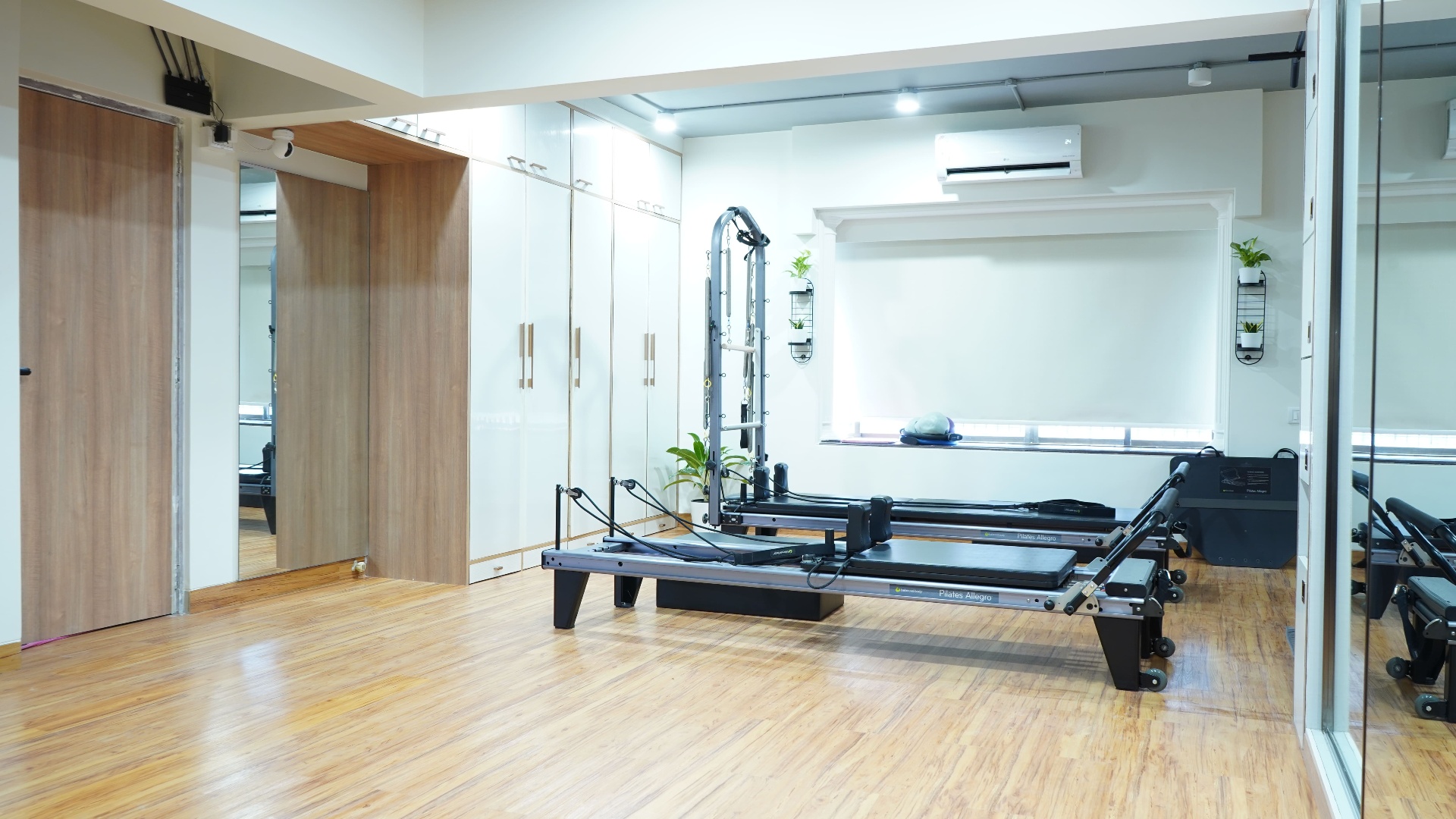Spacious Pilates studio with wooden floors